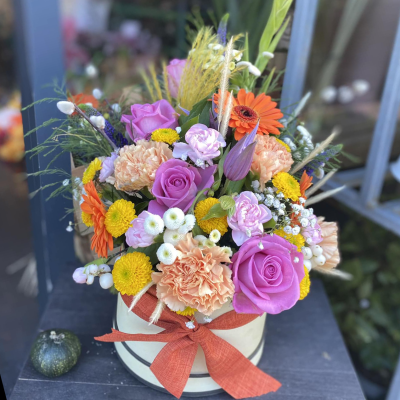 Simply The Best - A beautiful hat-box filled with a vibrant collection of flowers and foliage.